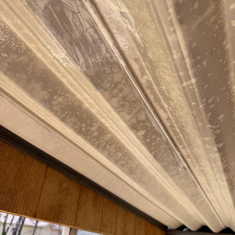 Metal garage door panel with rust and paint damage