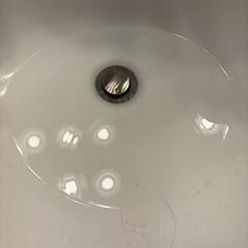 Pop-up drain in bathroom sink cleaning