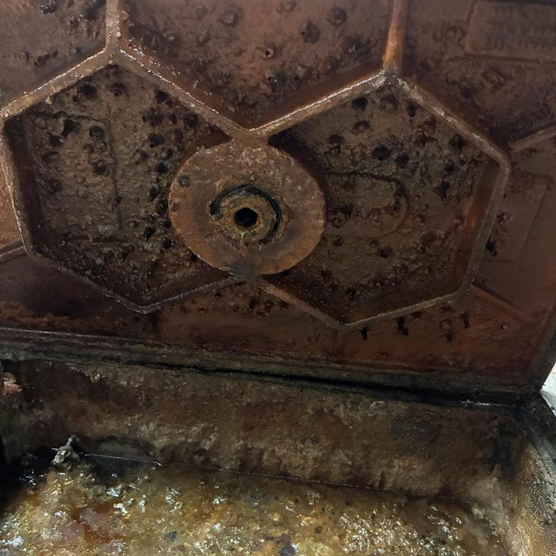 Grease trap lid interior with missing latch mechanism