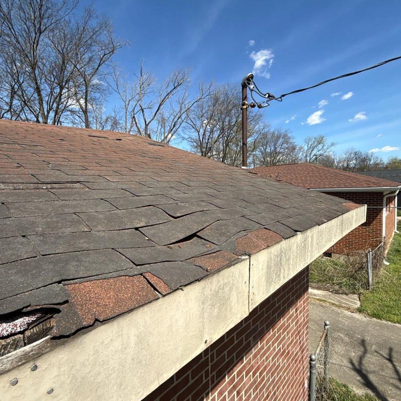 Asphalt shingle roof with hail damage and warping
