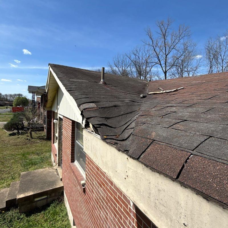 Asphalt shingle roof with hail damage and warping