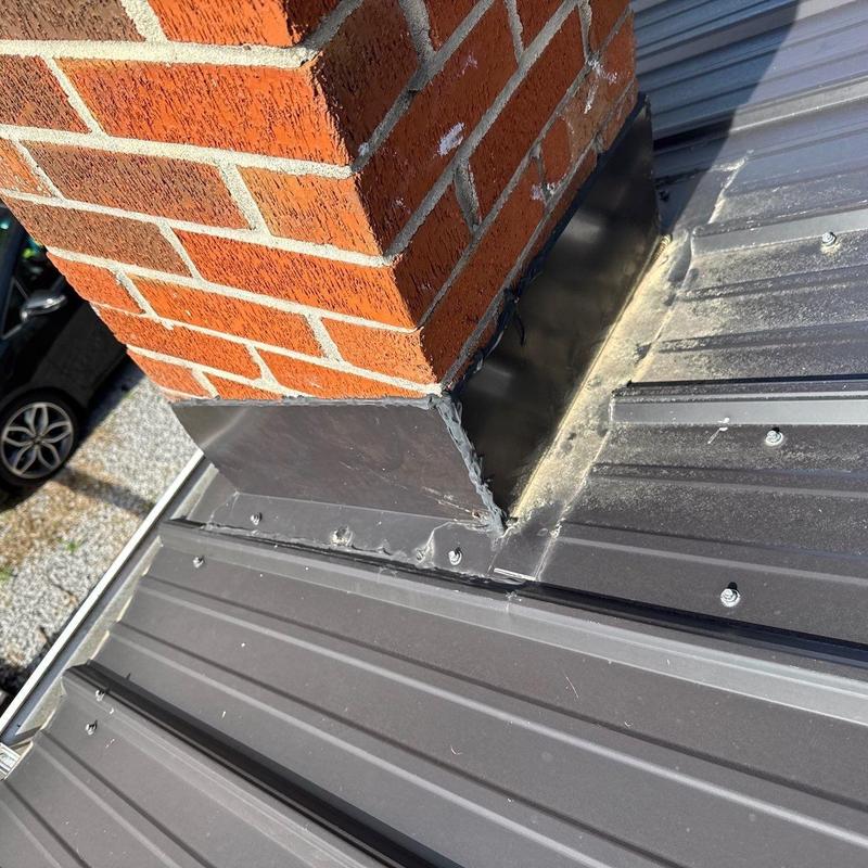 Chimney metal flashing on metal roof installation