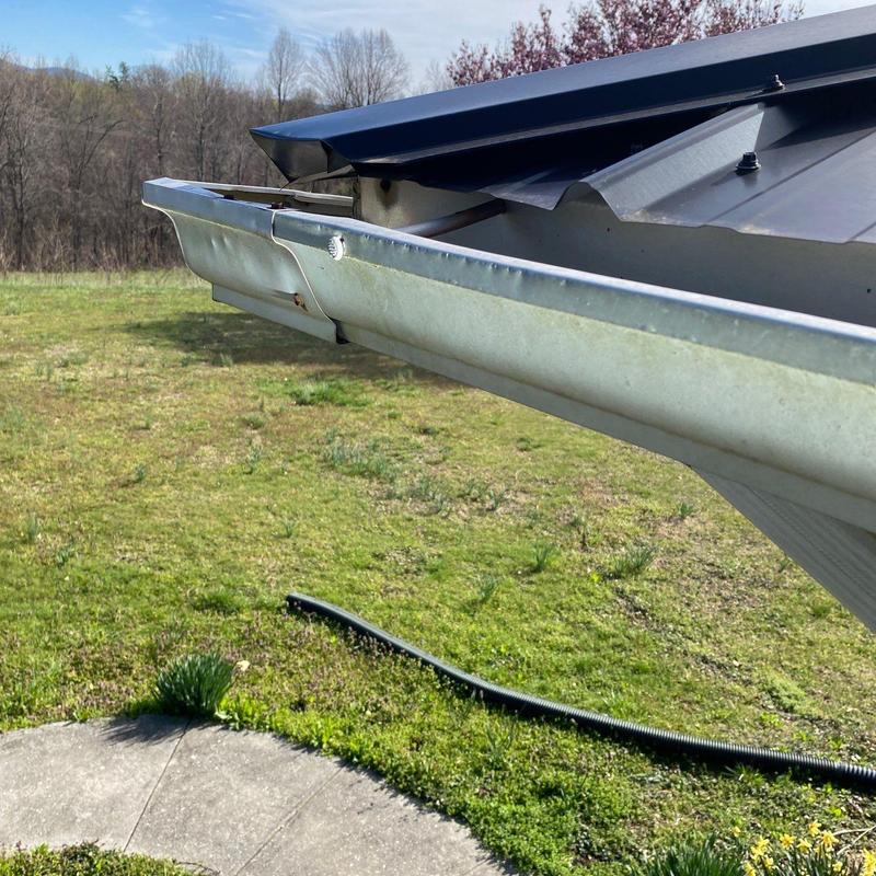 Metal roof gutter with slight dent near end cap