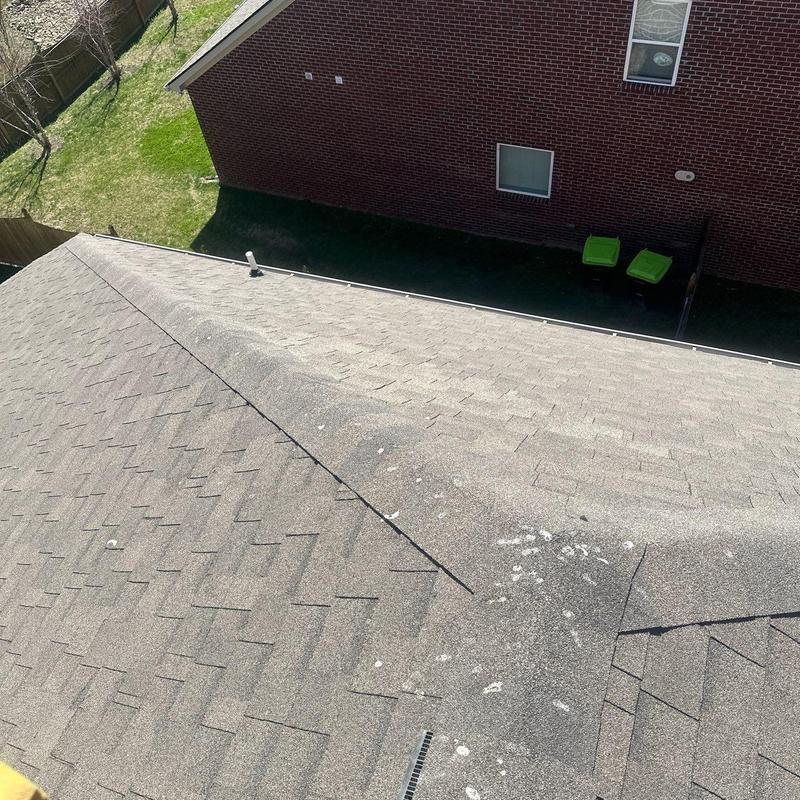 Asphalt shingle roof with visible hail damage spots