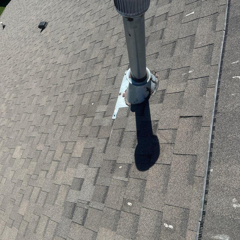 Roof vent pipe flashing with hail damage on shingles