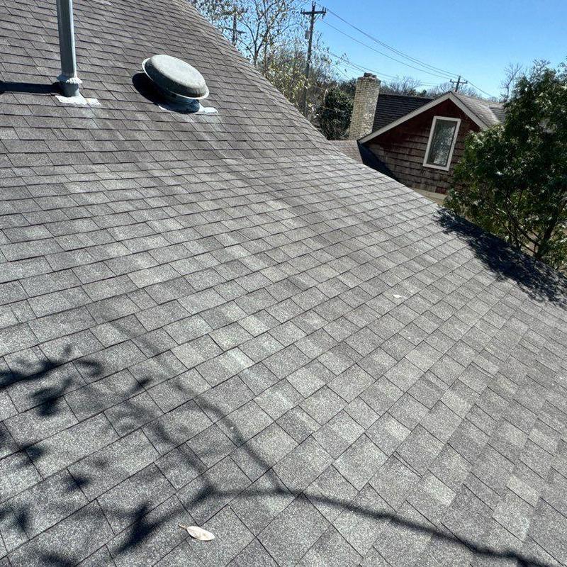 Asphalt shingle roof with hail damage and vent pipes