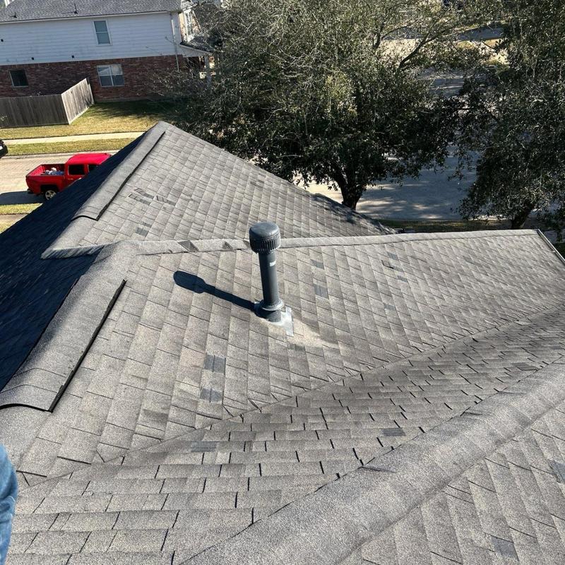 Asphalt shingle roof with visible storm damage