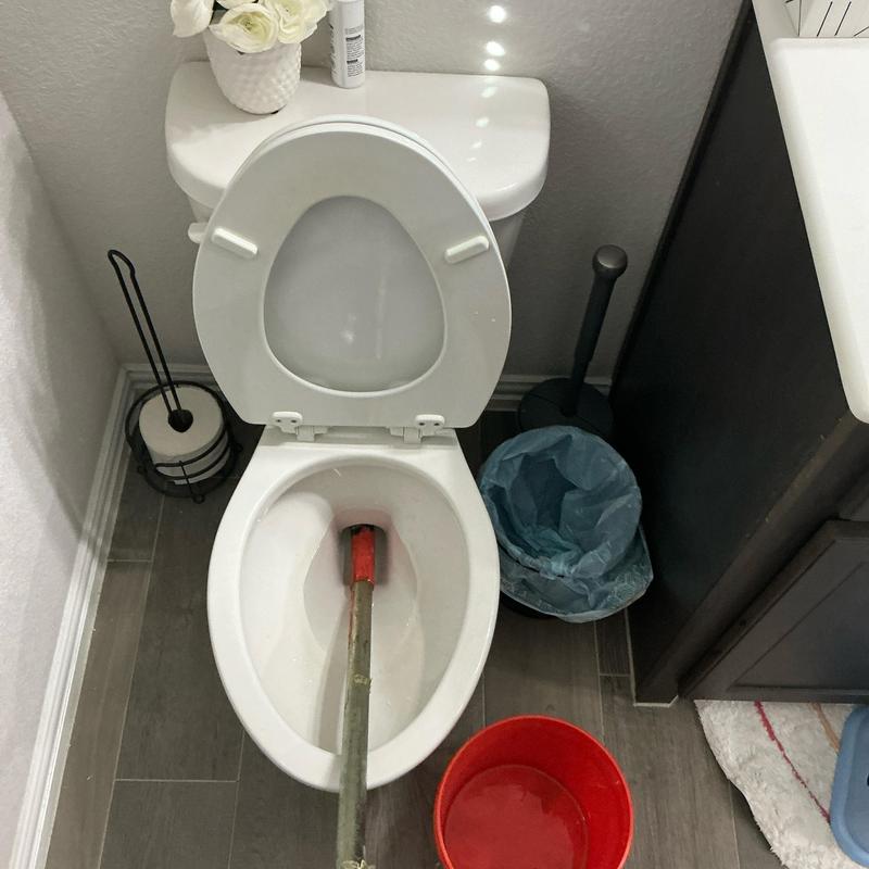 Toilet bowl auger clearing stoppage in P-trap drain line Toilet bowl auger clearing stoppage in P-trap drain line