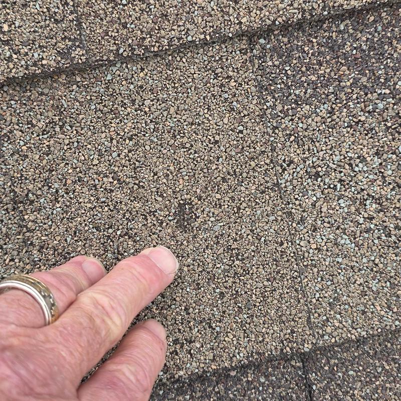 Asphalt roof shingles with hail damage close-up