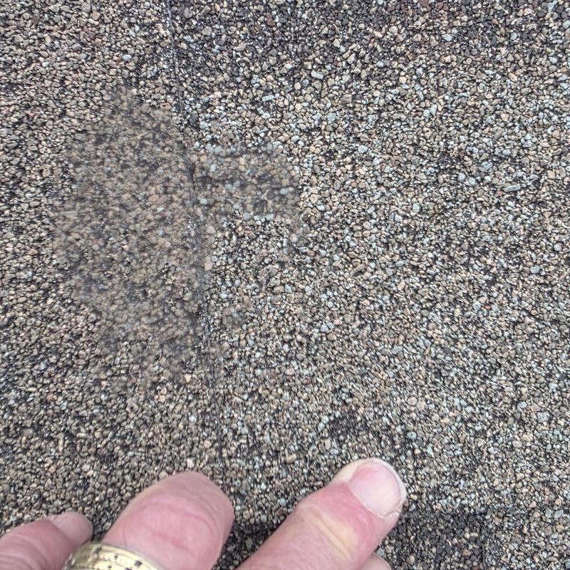 Asphalt shingle granule loss from hail damage close-up
