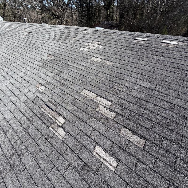 3-tab roof with missing shingles and granular loss