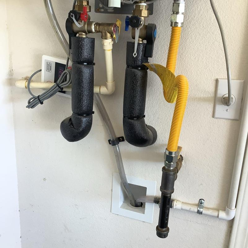 Tankless water heater heat exchanger with insulation pipes