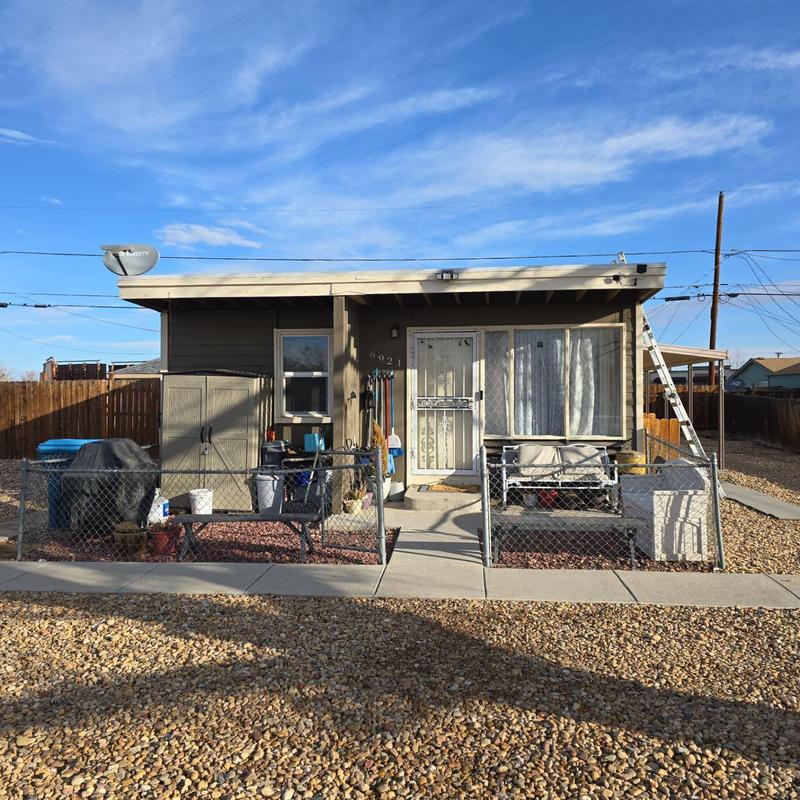 Flat roof with ladder and fenced backyard seating Flat roof with ladder and fenced backyard seating