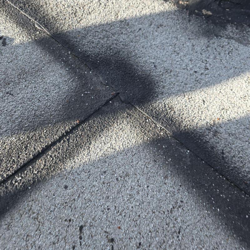 Flat roof seam with signs of degradation and wear Flat roof seam with signs of degradation and wear