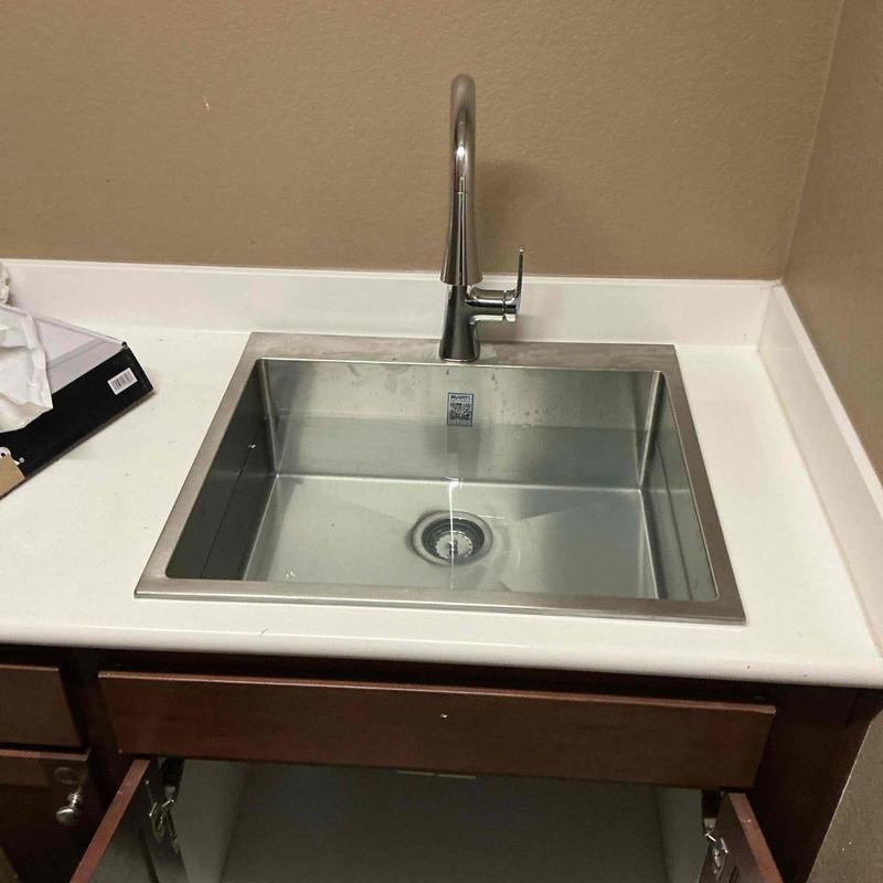 Kitchen sink and faucet installation on countertop