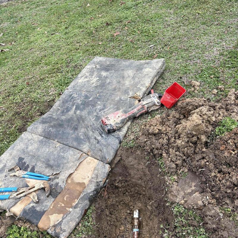 Underground water pipe leak with excavation and tools