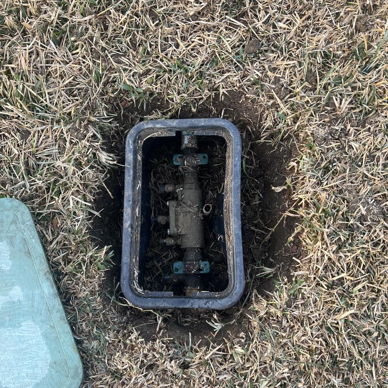 Water main valve box installed in lawn hole
