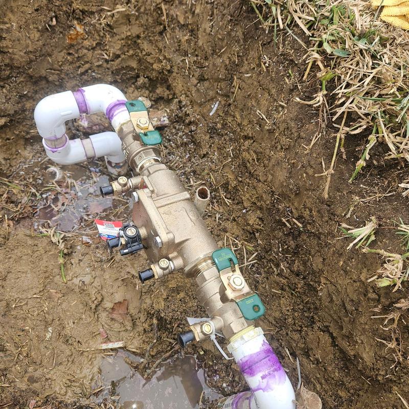 Water main valve assembly with PVC piping in soil