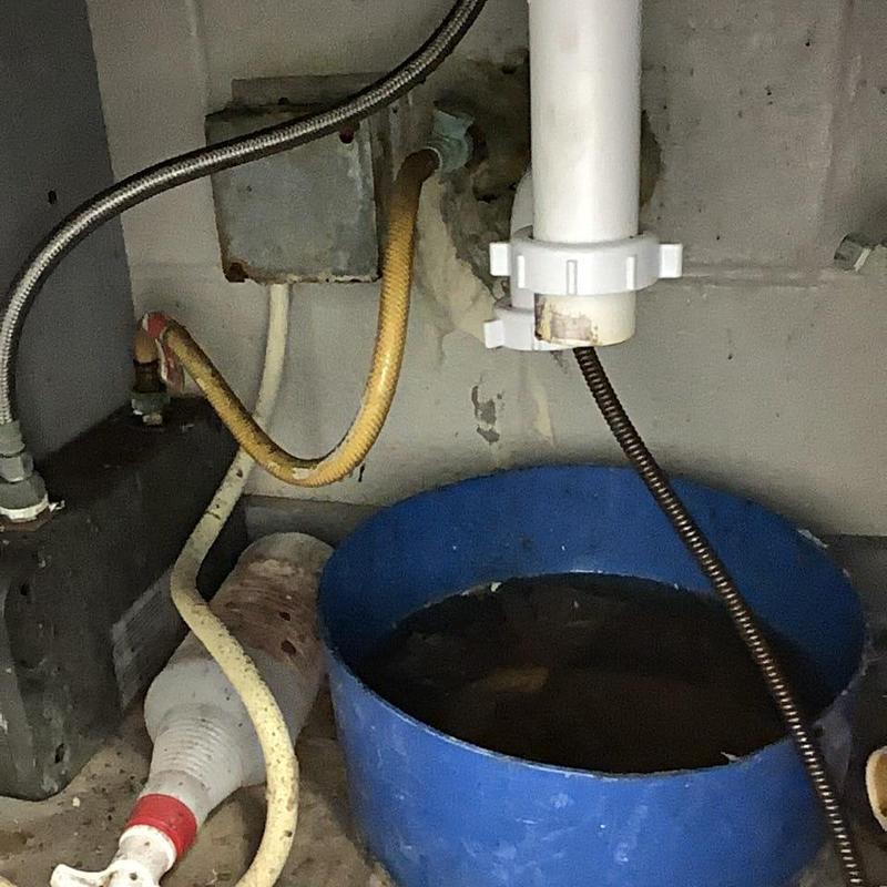 Toilet drain auger cable with laundry line under sink