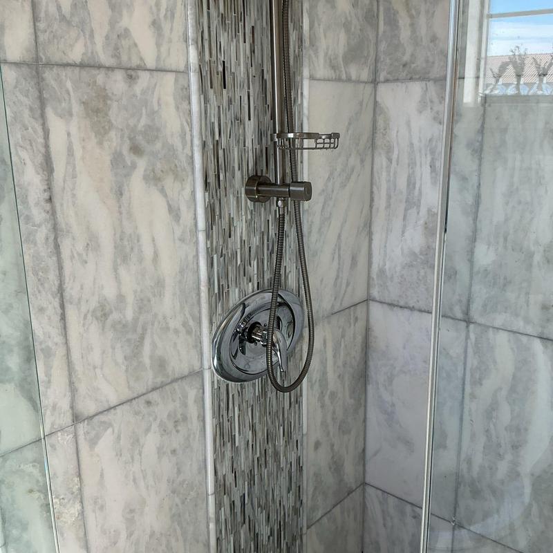 Shower valve and handheld showerhead in tiled shower