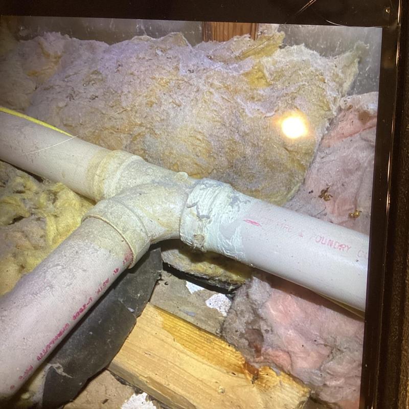 PVC vent tee pipe in attic with insulation