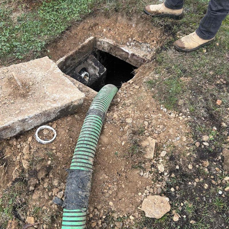 Septic tank with hose inserted for pumping