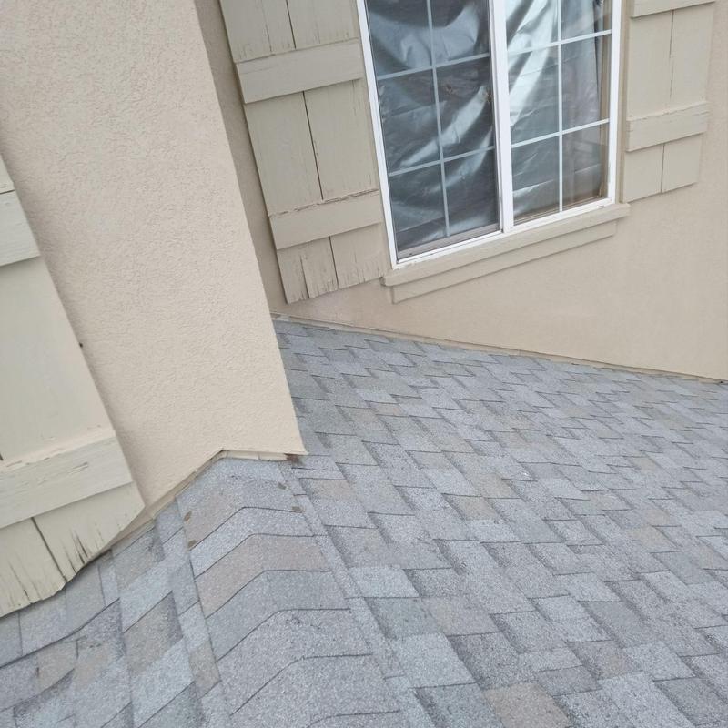 Asphalt shingle roof with hail damage near window Asphalt shingle roof with hail damage near window