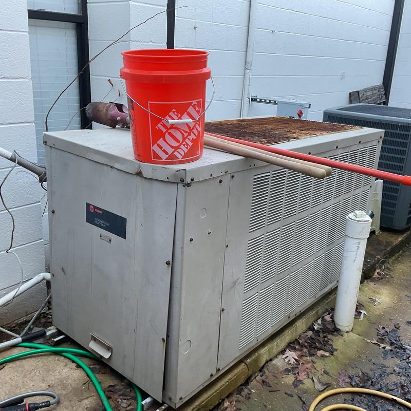 7.5 ton Trane outdoor HVAC unit with tools on top