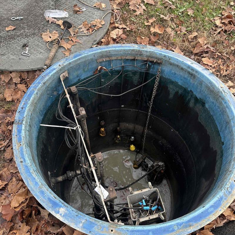 Sump pump system with faulty pump pulled from pit