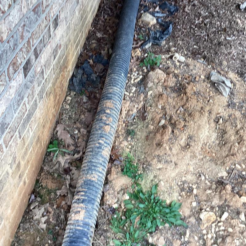 PVC pipe fitting replacement in soil near foundation wall