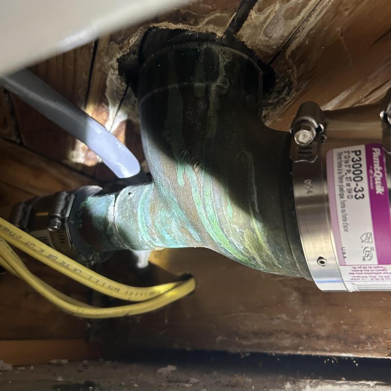 Cast iron drain pipe with coupling repair in crawlspace Cast iron drain pipe with coupling repair in crawlspace