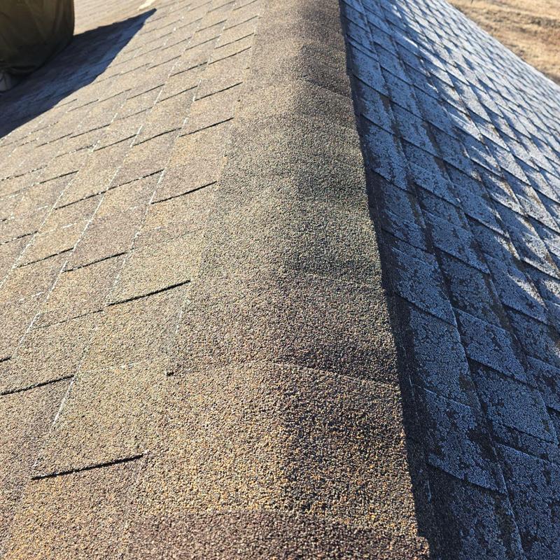 Asphalt shingle roof with ridge cap and wear signs Asphalt shingle roof with ridge cap and wear signs