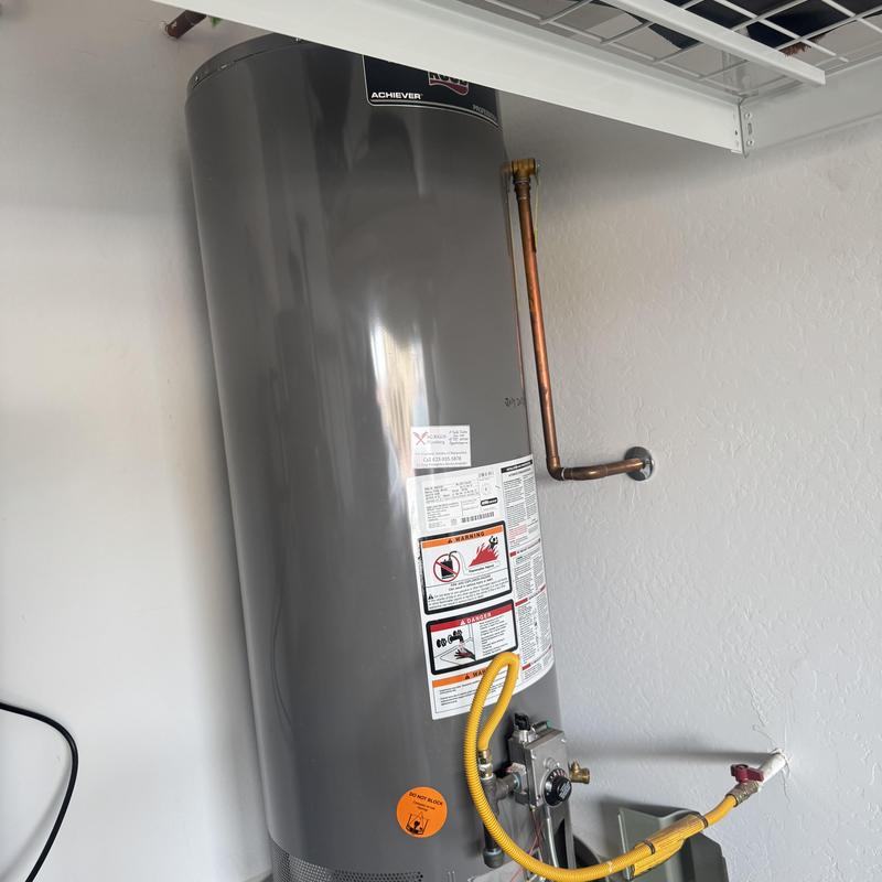 Water heater with copper piping and warning labels