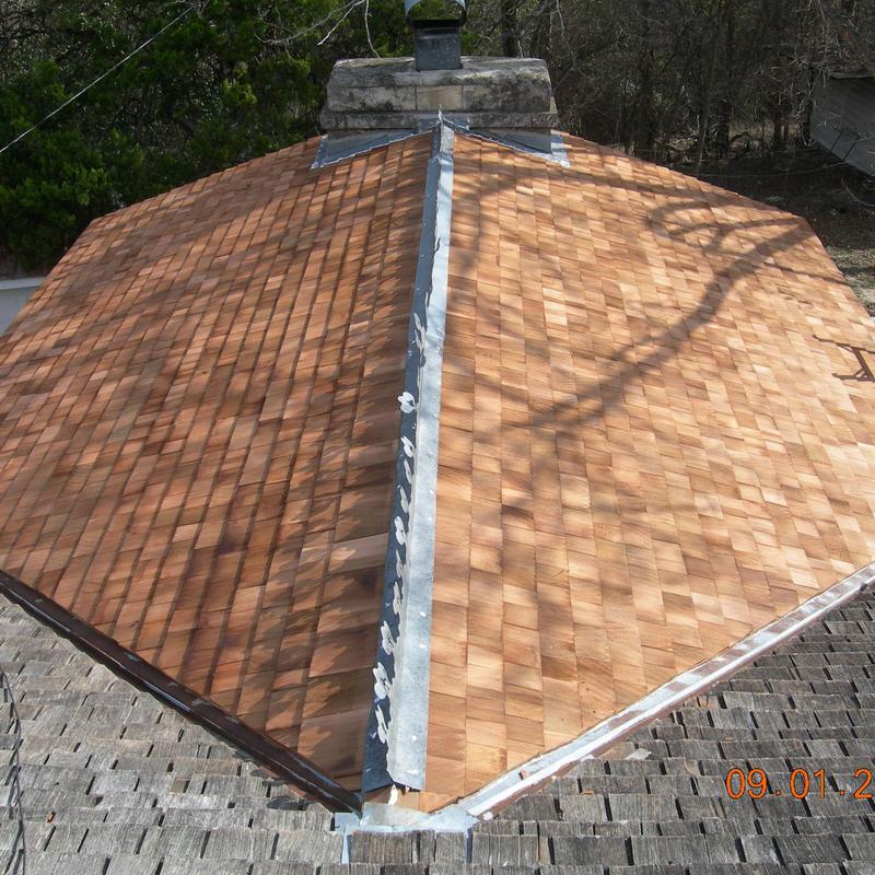 Wooden shake shingles roof with metal ridge cap Wooden shake shingles roof with metal ridge cap
