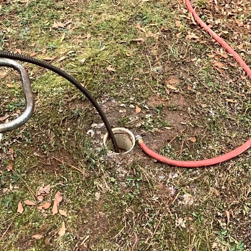 Main sewer line cleaning with drain snake and hose