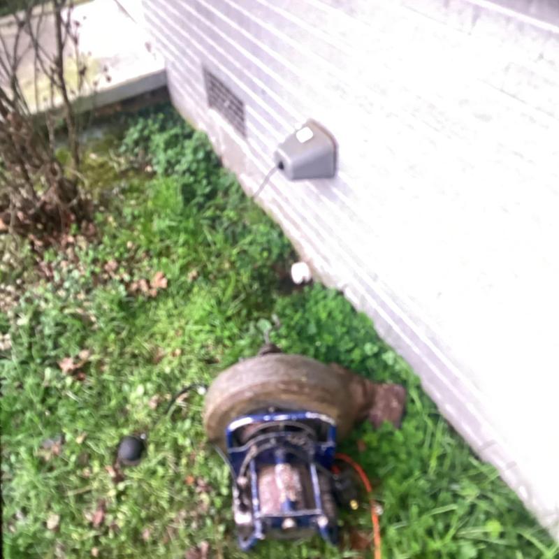 Kitchen drain line cleaning machine outside house wall