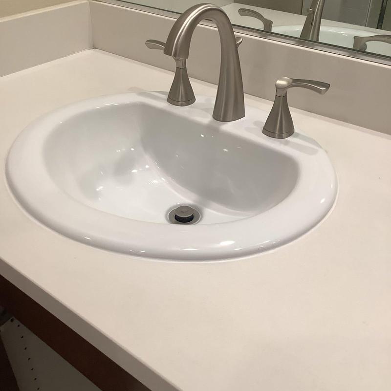 Bathroom sink with widespread faucet and pop-up drain