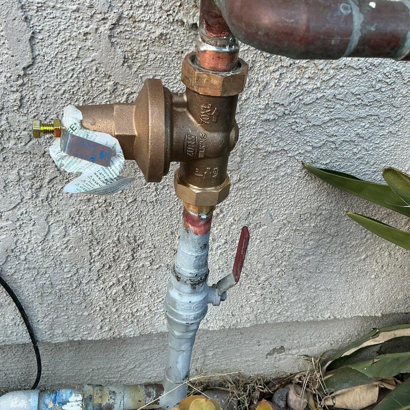 Pressure regulator valve on outdoor plumbing line