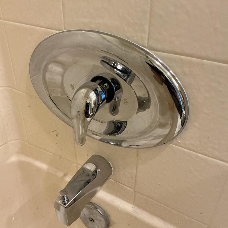 Tub diverter and shower trim installed with caulk seal