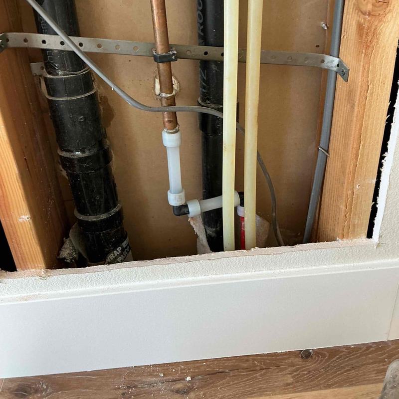 PVC and copper pipe section with 90-degree elbows installation