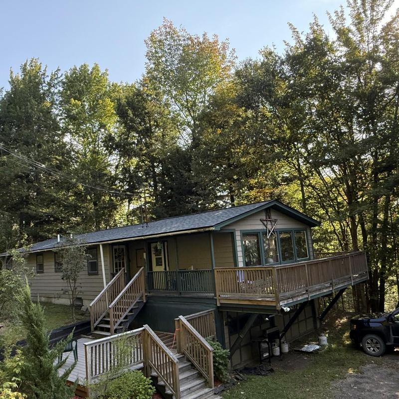Asphalt shingle roof on wooded residential home