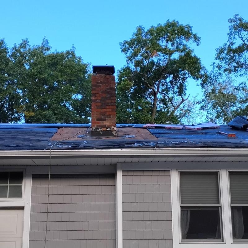 Asphalt shingle roof tear-off with chimney flashing prep