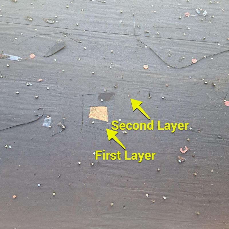 Roof decking exposed beneath multiple felt layers