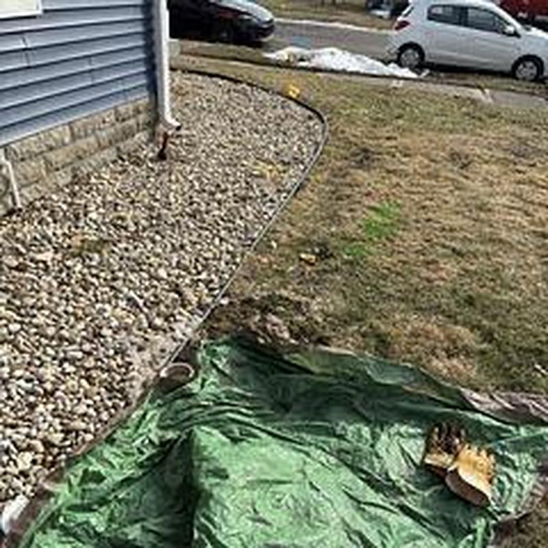 Collapsed outside sewer line with excavation tarp nearby