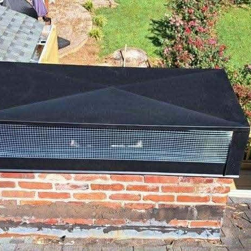 Chimney cap with metal mesh on brick chimney Chimney cap with metal mesh on brick chimney