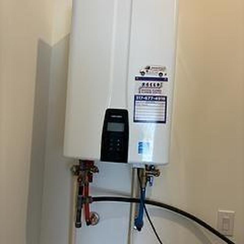 Tankless water heater with visible supply lines