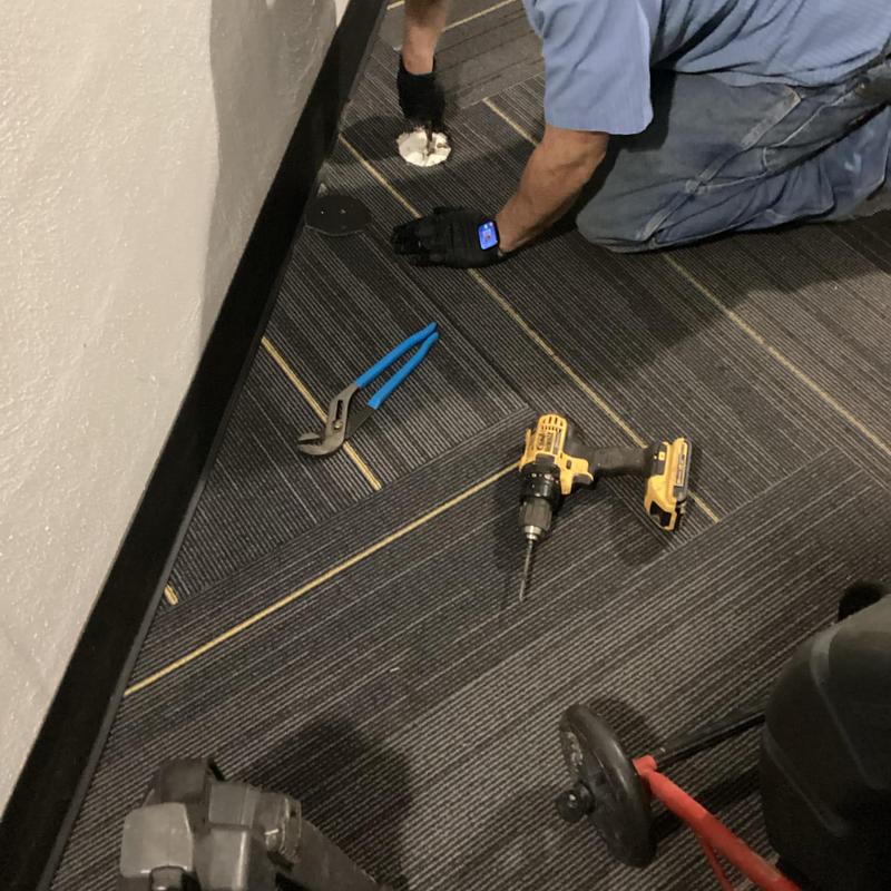 Sewer cleanout access and repair tools on floor