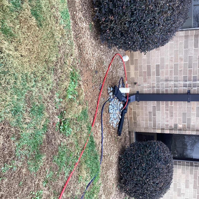 Hydro-jet drain line cleaning outside building wall