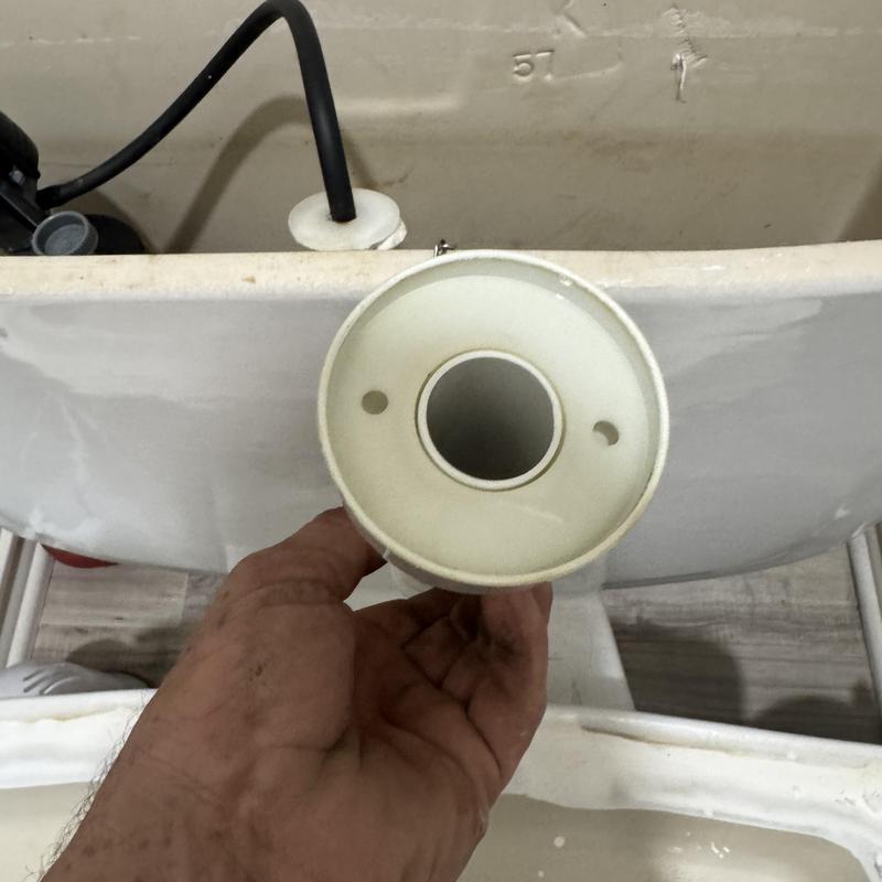 Toilet tank flapper gasket replacement in progress