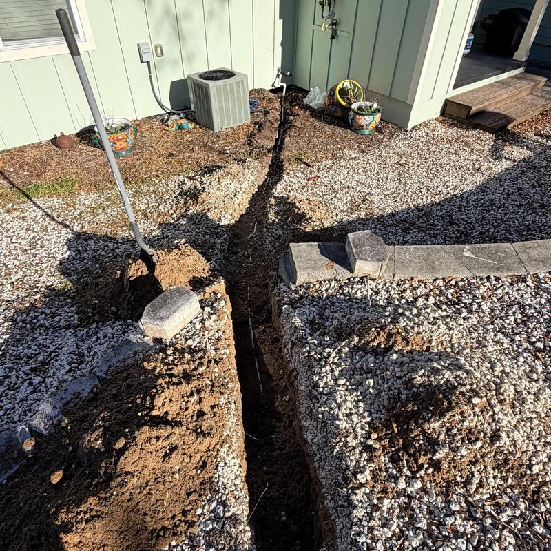 34 PVC water line trench excavation near house exterior